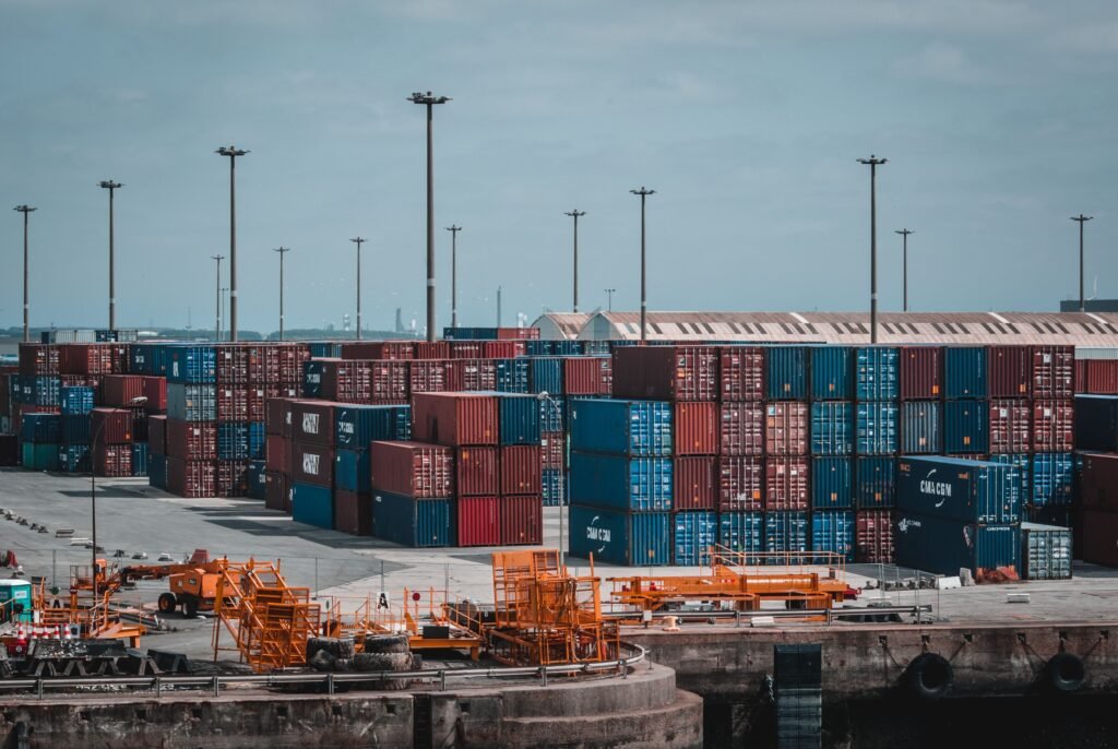 Cargo containers being loaded at warehouse for freight forwarding