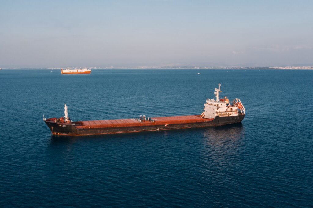 Aerial view of a cargo ship sailing across the open sea