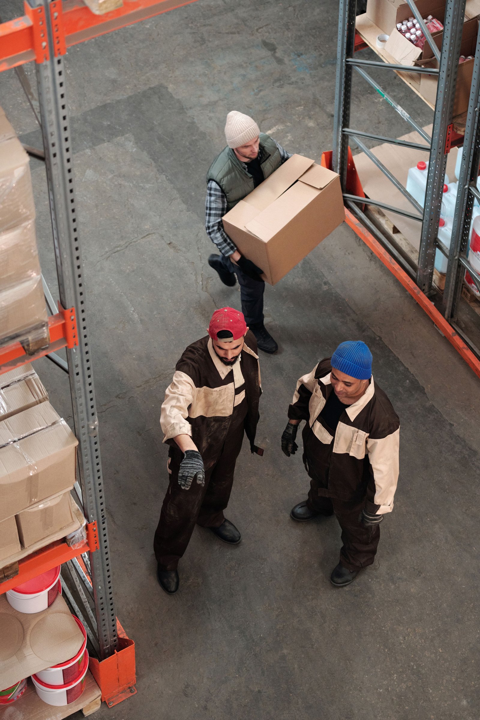 Warehouse workers handling and consolidating cargo boxes for sea freight shipment