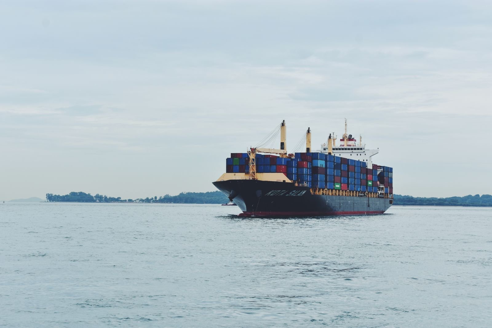 Loaded container ship sailing on a calm sea