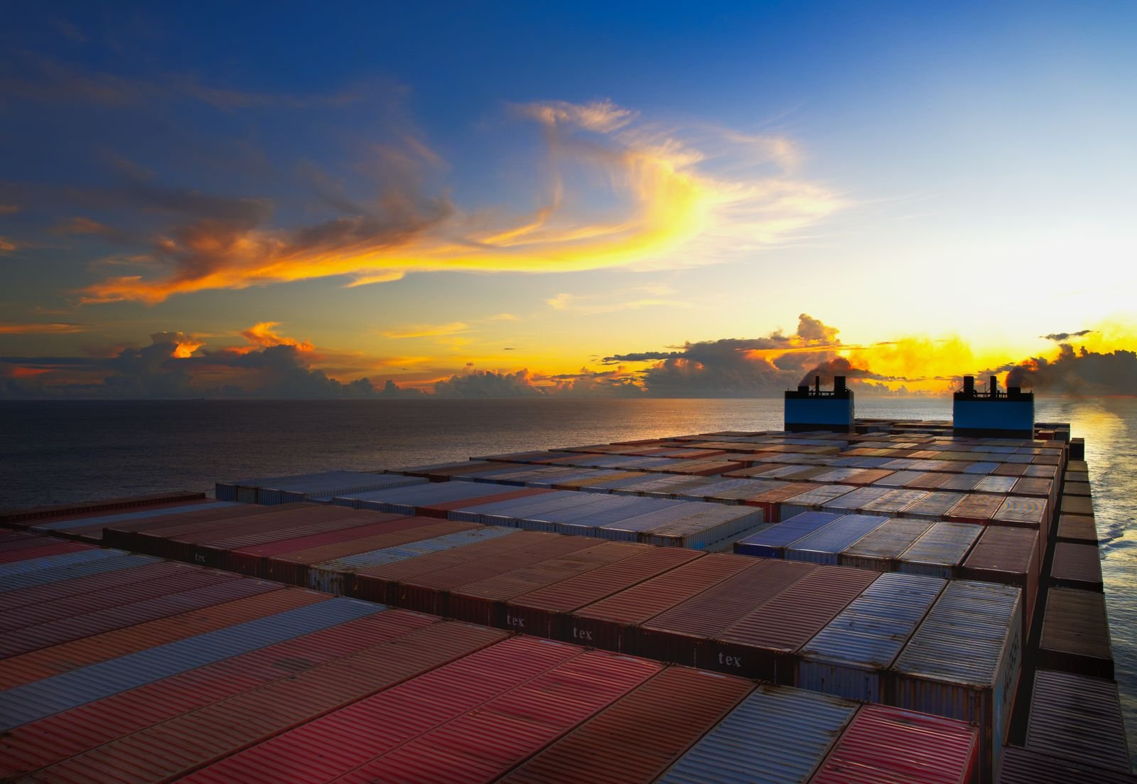 Aerial view of containers on a vessel at sunset